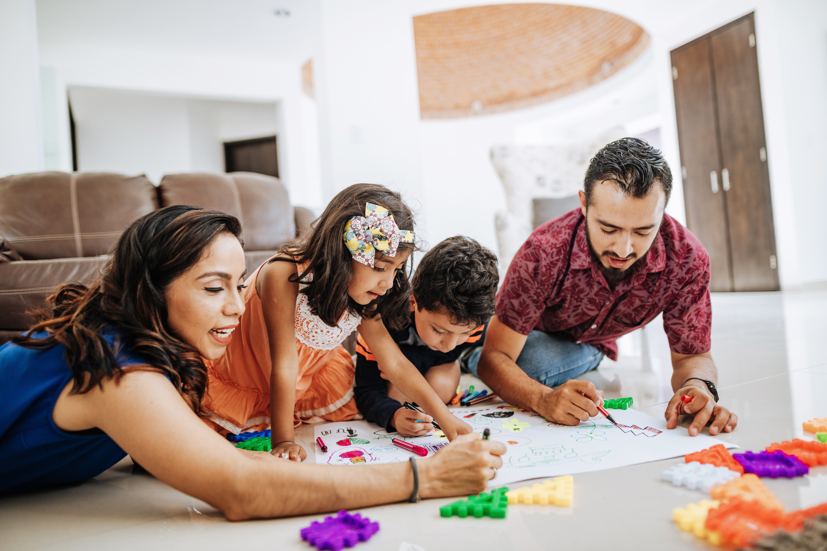 Latin parents playing with children at home